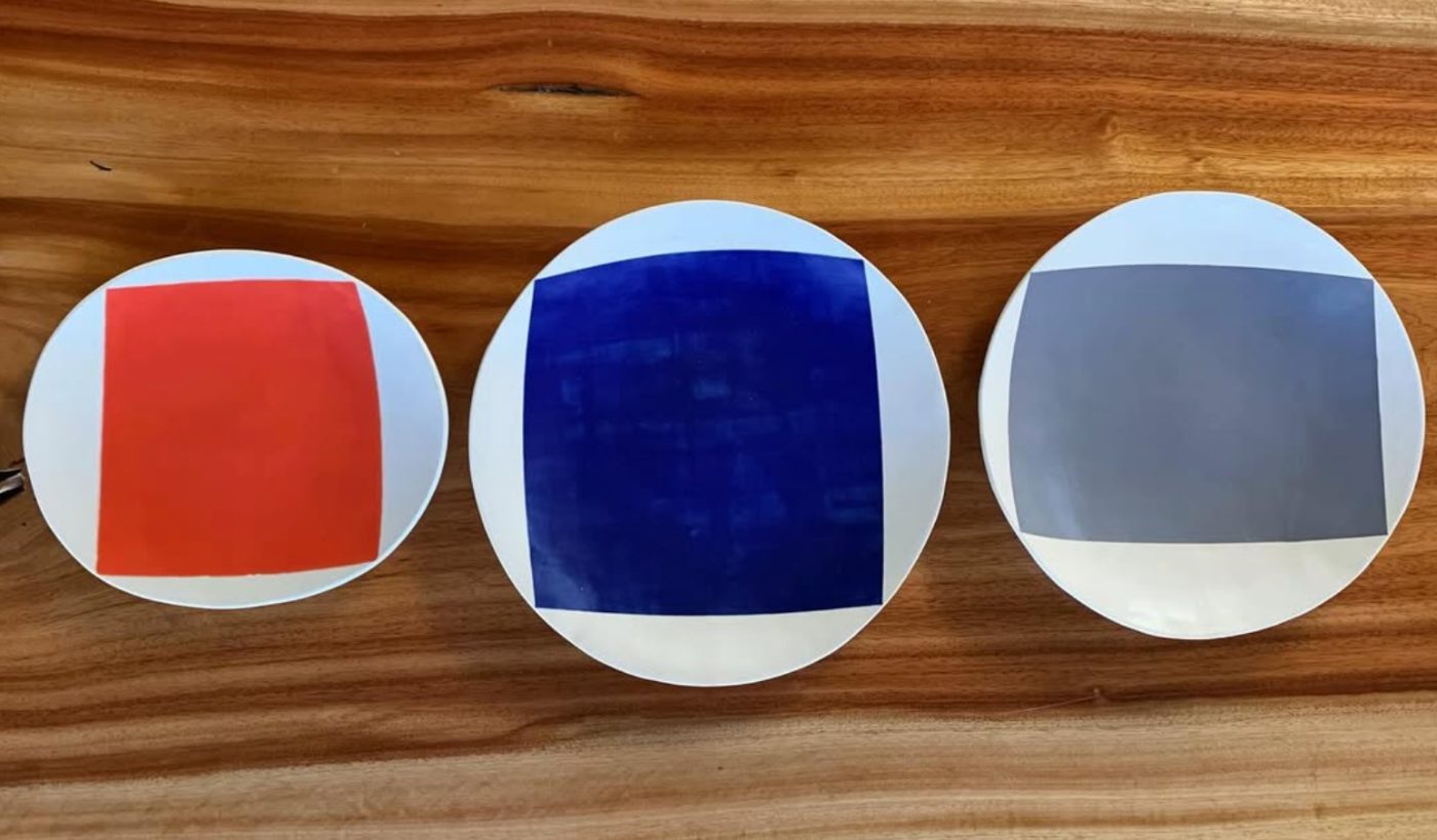 Three color-block plates on wood